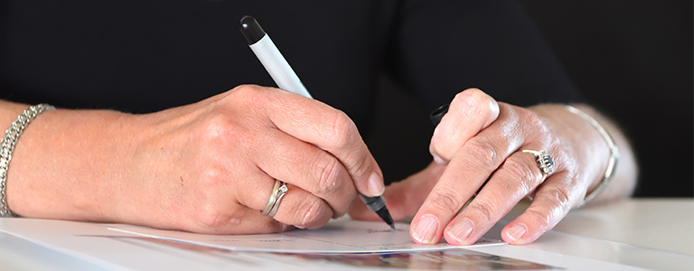 woman signing a will real family law north dakota